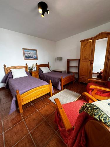 a bedroom with two beds and a mirror at CASA COREA IV in Puntagorda