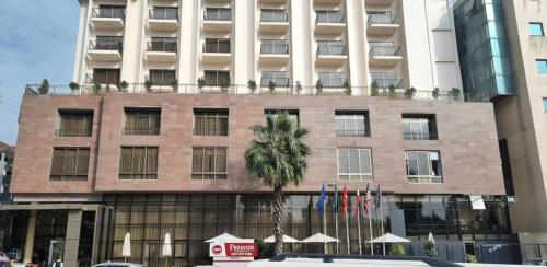 a building with a palm tree in front of it at Best Western Premier Dynasty in Addis Ababa