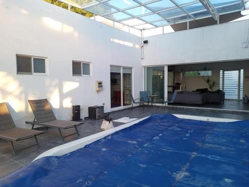 a large swimming pool with a blue tarp on it at Casa Blanca Tenextepec Atlixco. 