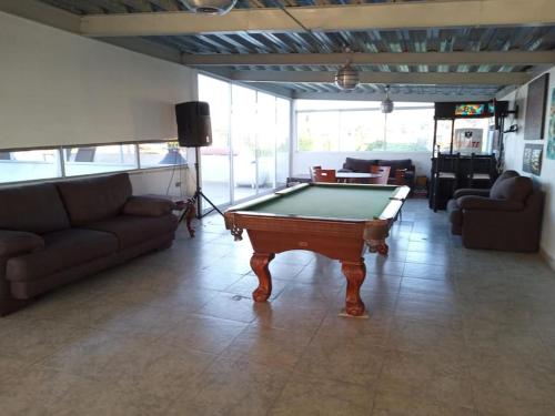 a living room with a pool table and couches at Casa Blanca Tenextepec Atlixco. 