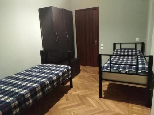 a bedroom with two bunk beds and a closet at For Daily Rent in Tbilisi City