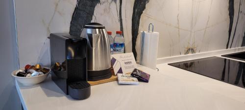 a kitchen counter with a coffee maker on a counter top at Spacious Apt With Balcony- Tranquil City Haven in Istanbul