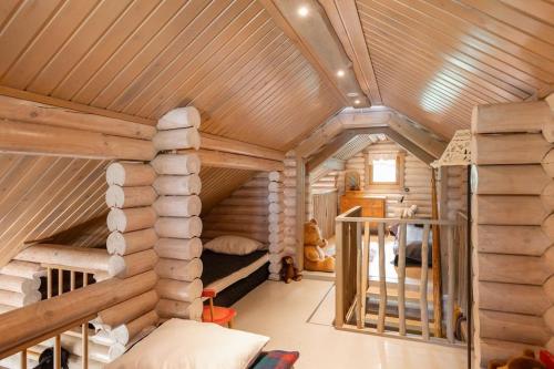 a log cabin with a bunk bed in a room at Cottage with Hot tub and Sauna in Uurainen
