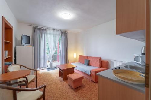 a living room with a couch and a table at Penzión Živa Bijacovce in Bijacovce