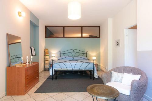 a bedroom with a bed and a chair and a table at CASOLARA: ospitalità su misura in Castello di Serravalle