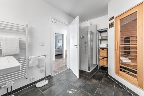 a bathroom with a sink and a shower at Am Yachthafen in Olpenitz