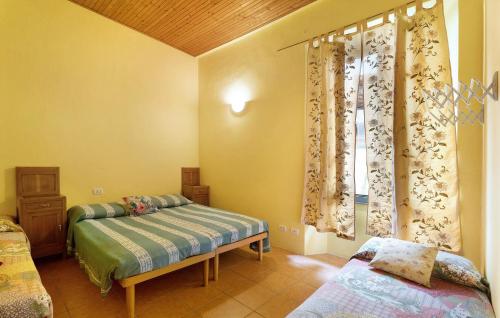 a bedroom with two beds and a window at Ostello del Quadrifoglio in Ameno