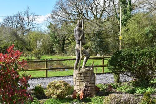a statue of a woman standing on a stone pillar at Yr Hen Beudy Barn Conversion Sleeps 4 Dogs Ok in Carmarthen