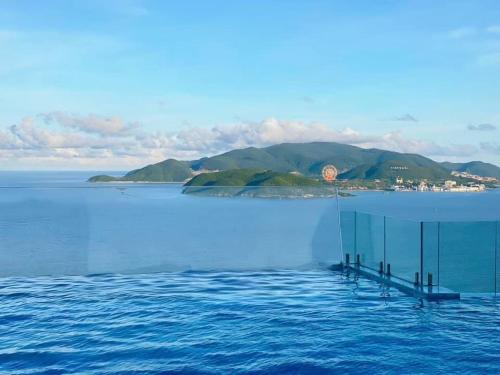 a view of the water with an island in the background at SeaScape Panorama Grand Resicedences Nha Trang in Nha Trang