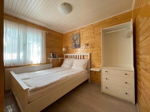 a bedroom with a large bed and a window at Zegzug Noszvaj in Noszvaj