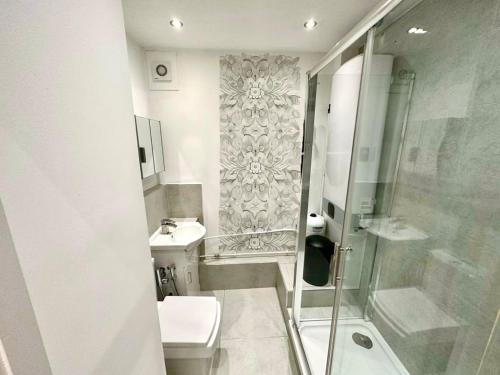 a bathroom with a shower and a toilet and a sink at 2 minutes from Marble Arch, in Central London, Private Room E in London