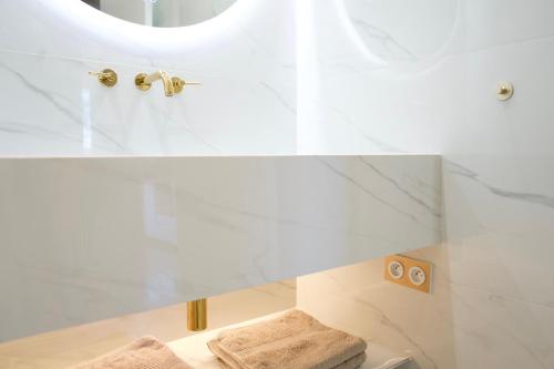 a white bathroom with a shower with a mirror at LE BAHIA in Nice