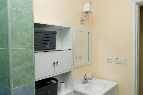 a bathroom with a sink and a mirror at Cossy homes in Nakuru