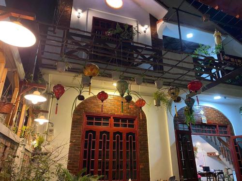 a building with a red door and flowers on the ceiling at SEVEN HOMESTAY(HUE) in Hue