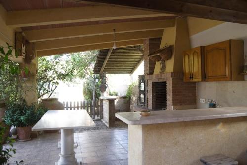 an outdoor kitchen with a table and a stove at Villa en la Vega del pueblo in Cantoria