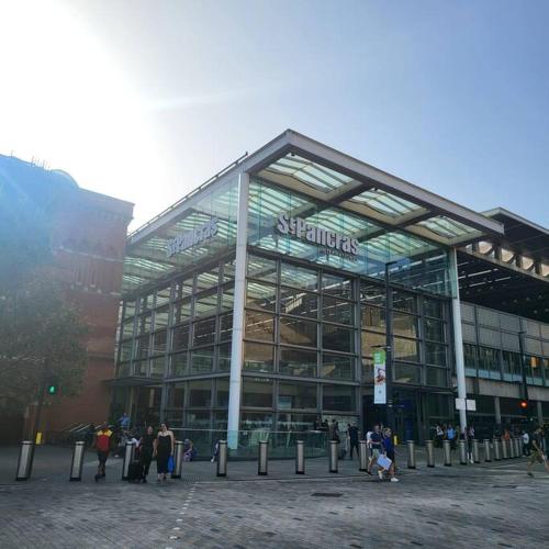 a large glass building with people standing outside of it at London Apartment - Near Kings Cross St Pancreas! in London