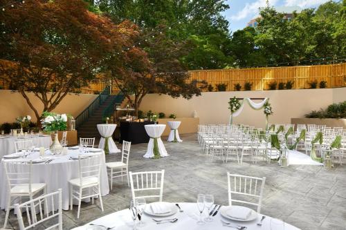 a row of tables and chairs with white table cloths at Falls Church Marriott Fairview Park in Falls Church