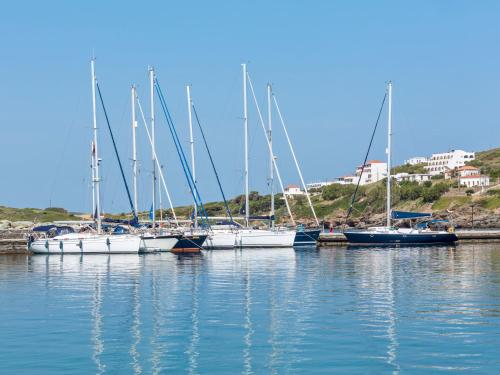 a group of sailboats are docked in the water at Paradise Design Apartments in Batsi