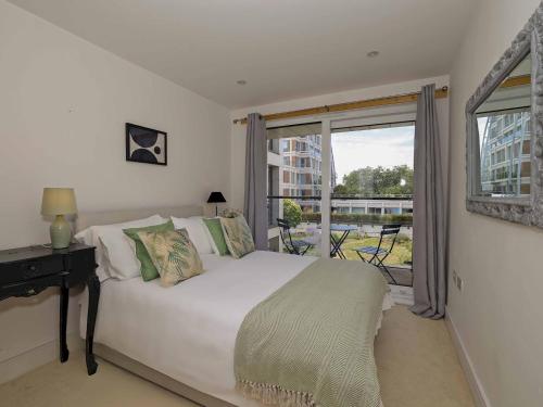 a bedroom with a white bed and a window at Pass the Keys Stylish comfortable apartment in central Kingston in Kingston upon Thames
