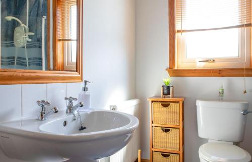 a bathroom with a sink and a toilet at Tulm Bay in Kilmaluag