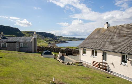 a house on a hill with a view of the ocean at Tulm Bay in Kilmaluag