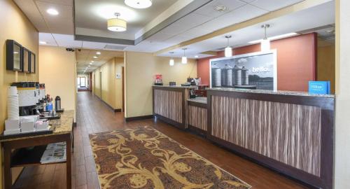 a lobby of a hotel with a counter and a bar at Hampton Inn Dry Ridge in Dry Ridge
