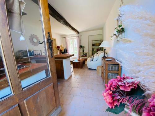 a room with a door and a living room at Appart Karibu in Callian