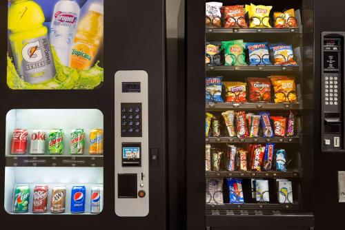 a vending machine filled with lots of drinks and snacks at Baymont by Wyndham Cedar Rapids in Cedar Rapids