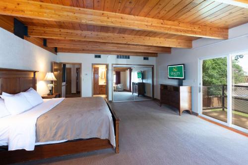 a bedroom with a large bed and a tv in it at Quality Inn in Havre