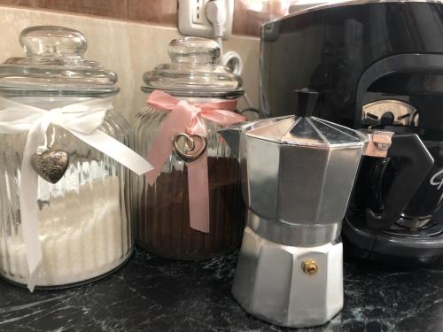 a counter top with two glass jars and a blender at Garsoniera Relax Drumul Taberei in Bucharest
