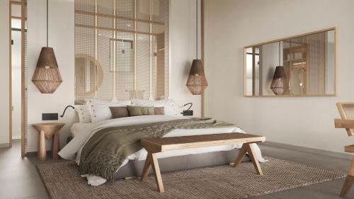 een slaapkamer met een bed, een bank en een spiegel bij HL Miraflor Suites Hotel in Playa del Inglés