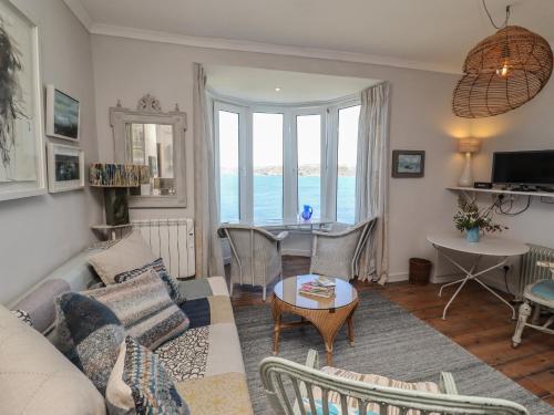 a living room with a couch and a table at Starfish in Penzance
