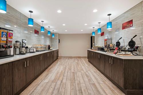 a kitchen with wooden cabinets and blue lights at Best Western Plus Greenwood Indy South Inn in Greenwood