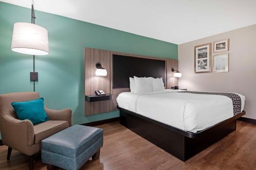 a hotel room with a bed and a chair at Best Western Plus Greenwood Indy South Inn in Greenwood