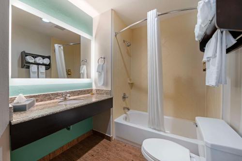 a bathroom with a tub and a toilet and a sink at Best Western Plus Greenwood Indy South Inn in Greenwood