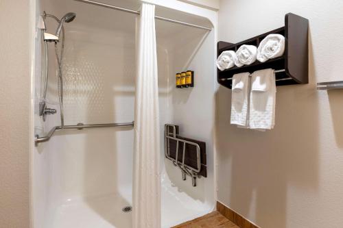 a bathroom with a shower and a toilet and towels at Best Western Plus Greenwood Indy South Inn in Greenwood