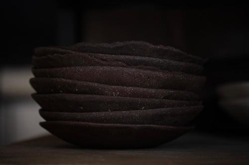 a stack of brown bowls sitting on a table at Aguamadera in Santa Eularia des Riu