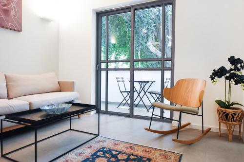 a living room with a couch and a table at Magic Lily by HolyGuest in Tel Aviv