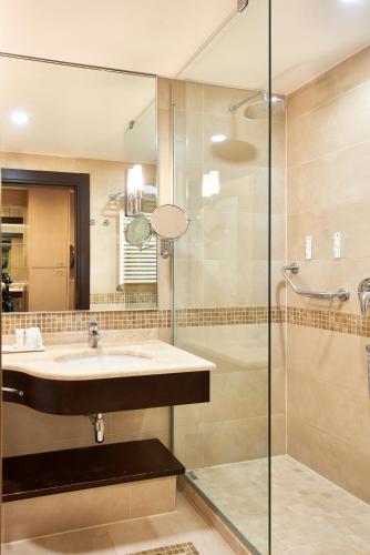 a bathroom with a sink and a shower at UNAHOTELS Varese in Varese
