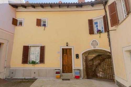a large yellow building with a door and windows at BEE HOUSE Ponzone in Ponzone