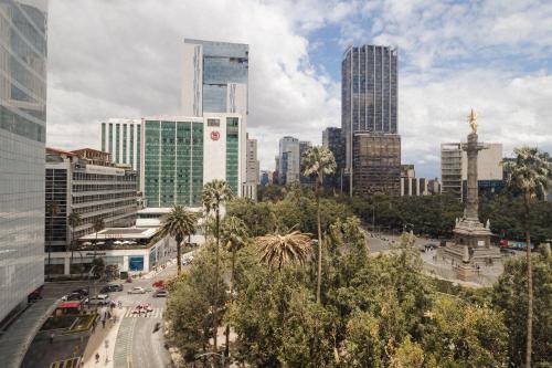 a city with tall buildings and a street with cars at Sonder Las Alas in Mexico City