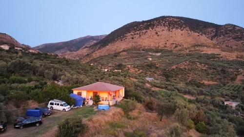 a house on a hill with a view of a mountain at Pablo's Moto Inn 