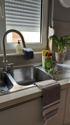a kitchen counter with a sink and a window at Casa Polizzi - Maison entière in Fontaine-lʼÉvêque
