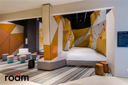 a room with a bed and a climbing wall at ViiA Residences Kuala Lumpur in Kuala Lumpur
