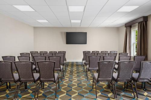 a conference room with chairs and a flat screen tv at Residence Inn Boston Franklin in Franklin