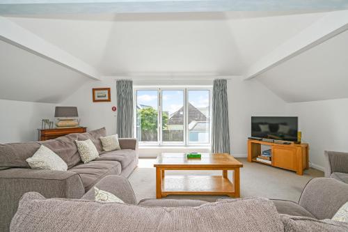 a living room with a couch and a tv at Marine House by inspirestays-com in East Wittering