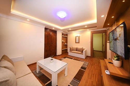 a living room with a couch and a table at Green Hill Apartment Kathmandu in Kathmandu