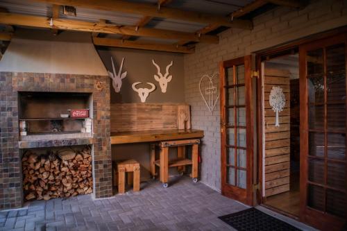 a room with a wooden desk and a fireplace at The Owl House in Jeffreys Bay