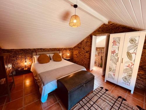 sypialnia z dużym łóżkiem na poddaszu w obiekcie Quinta Tilia - Farmhouse w mieście Oliveira de Azeméis