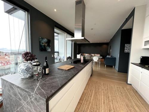 a kitchen with a counter and a large window at Jaw dropping New Penthouse apt in Svolvær in Svolvær